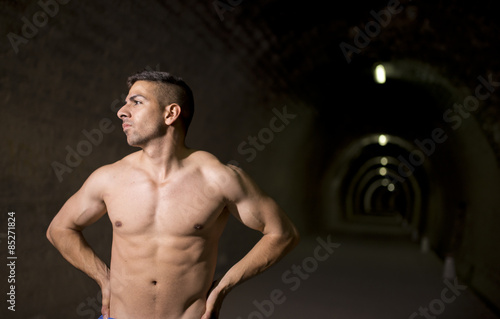 Young man posing in tunnel