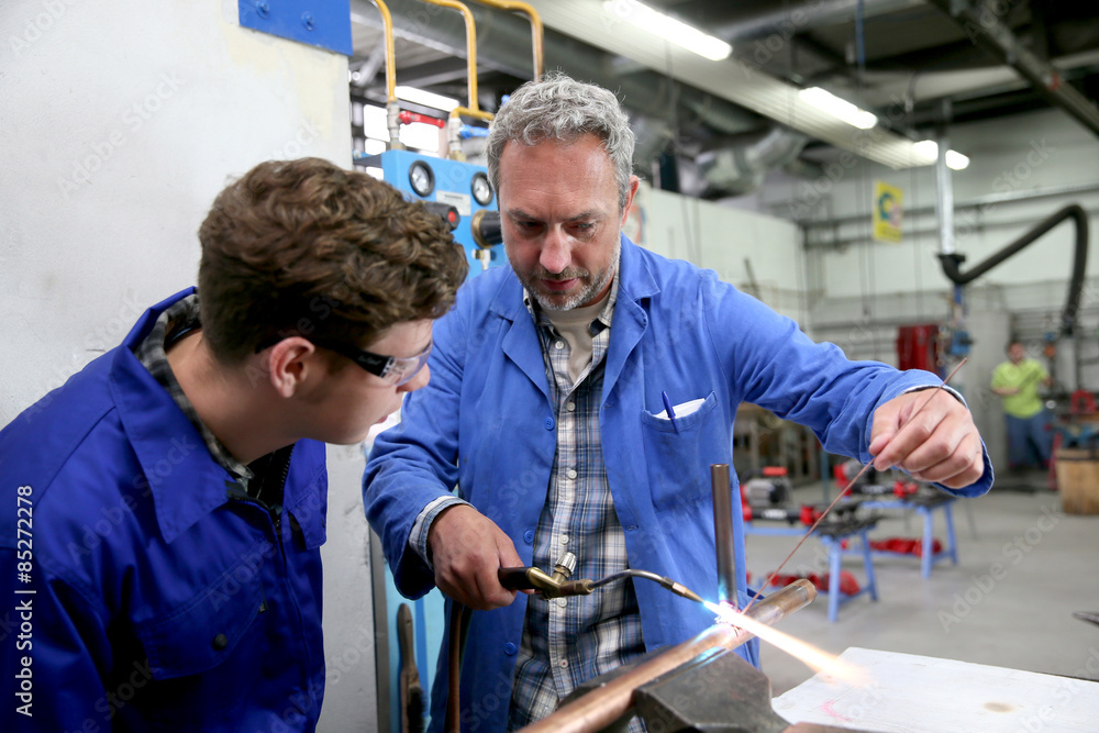 Teacher with student in metallurgy workshop Teacher with student in metallurgy workshop