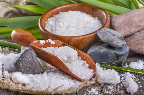 salt bath in wooden bowl with bamboo leaves in background