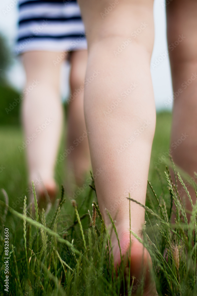 Barefoot girls in skirts on grass