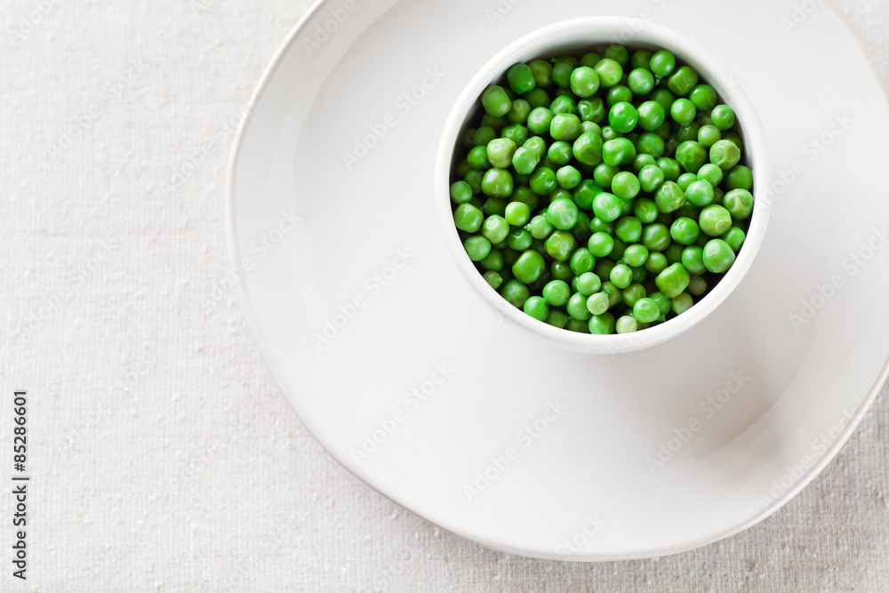 Cooked Peas from above in a white bowl with copy space. Cooked Peas from above in a white bowl with copy space.
