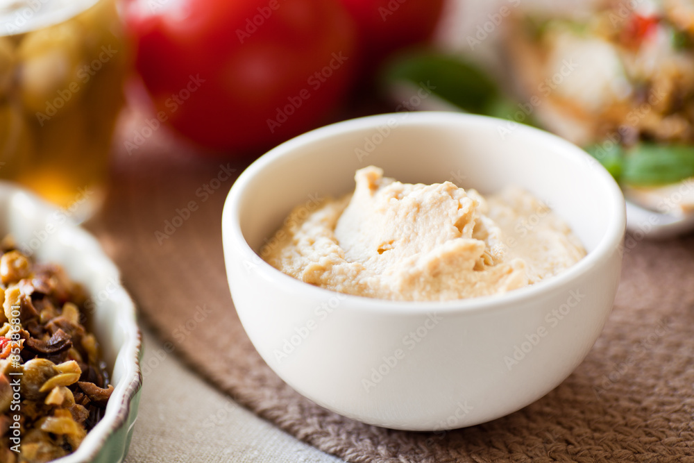 Bowl of Hummus Dip, olives, tomatoes as appetizers or healthy snack. Bowl of Hummus Dip, olives, tomatoes as appetizers or healthy snack.
