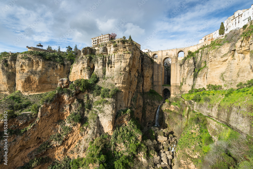 The City of Ronda, Spain. Wide angle view of buildings on sheer cliffs and the Puente Nuevo bridge built over Rio Guadalevin.