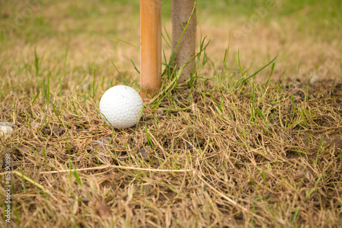 Close up dirty golf ball in bad ground