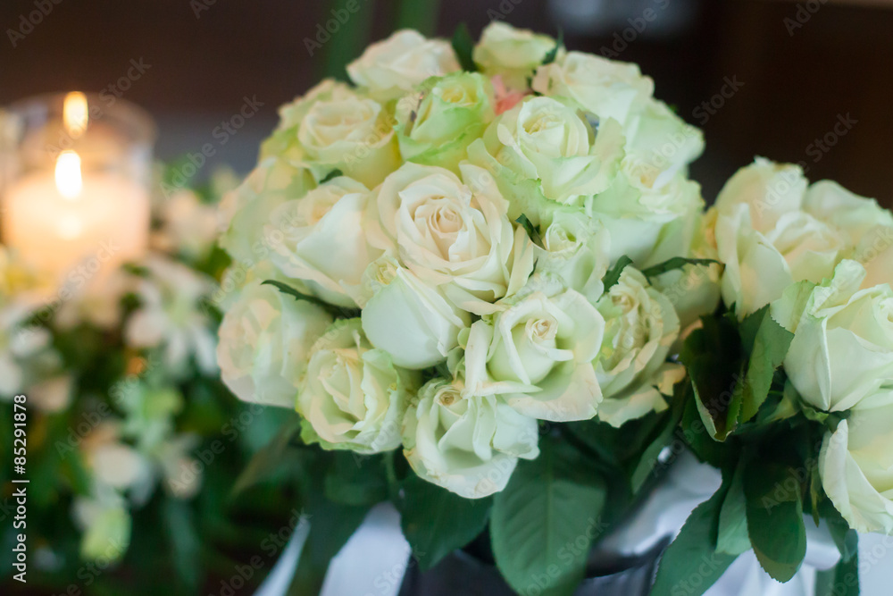 Candle and Wedding bouquet of white roses Candle and Wedding bouquet of white roses