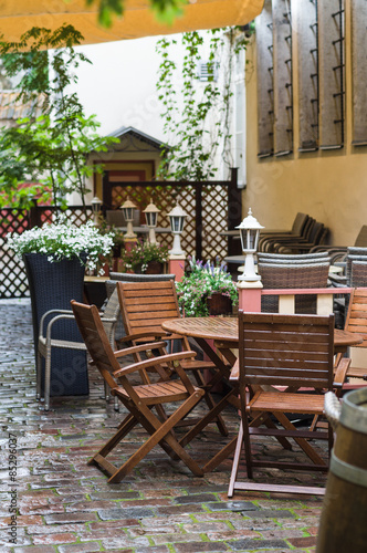 Romantic outdoor terrace on courtyard with flowers and lanterns