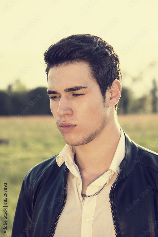 Handsome young man at countryside, in front of field or Handsome young man at countryside, in front of field or