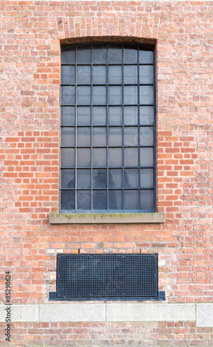 Window and Ventilator on brick wall.