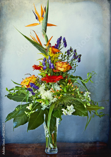 huge and elegant  bouquet of bird of paradise and mixed flowers on grunge background