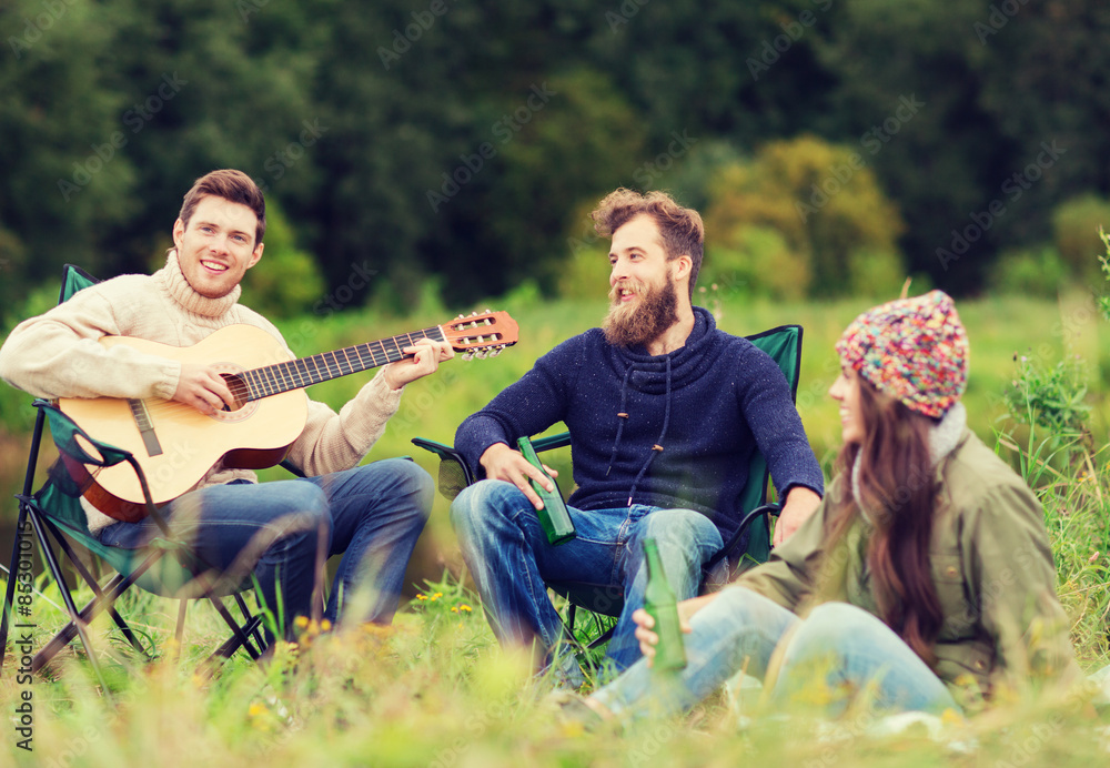 group of tourists playing guitar in camping group of tourists playing guitar in camping