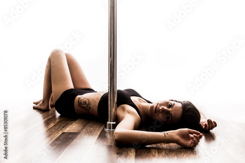 Beautiful young woman posing at pole