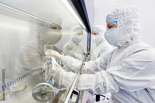 Картината върху платно workers in protective uniform at laboratory