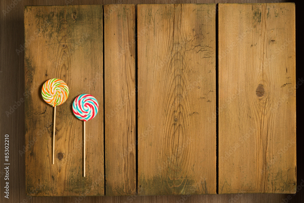 Christmas candy on picnic table/Lollipops arranged on wooden background Christmas candy on picnic table/Lollipops arranged on wooden background