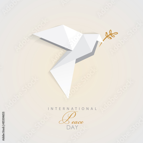 international peace day vector illustration of white origami dove bird with golden olive branch