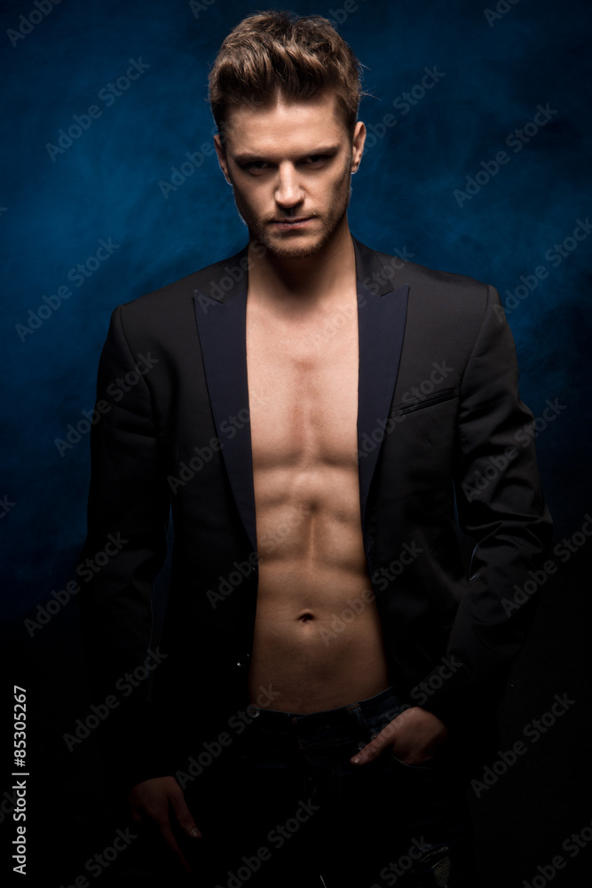 Young handsome man with muscle abdominal and open jacket.