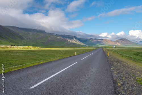 Icelandic paved road next to mountains.
