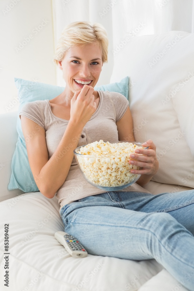 Portrait smiling blonde woman eating pop corn Portrait smiling blonde woman eating pop corn