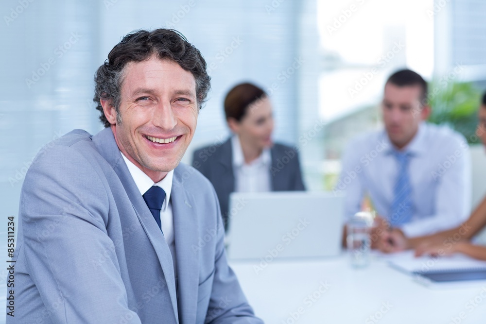 Smiling businessman looking at camera