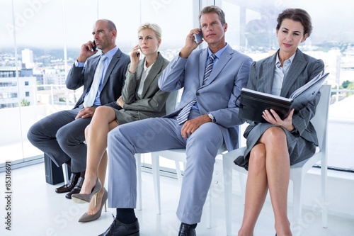 Business people waiting to be called into interview