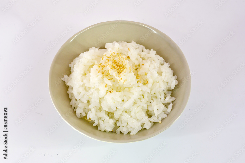 Cooked Rice topped with Sesame in white bowl isolate