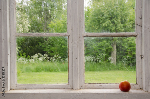 Red apple at an old windowsill
