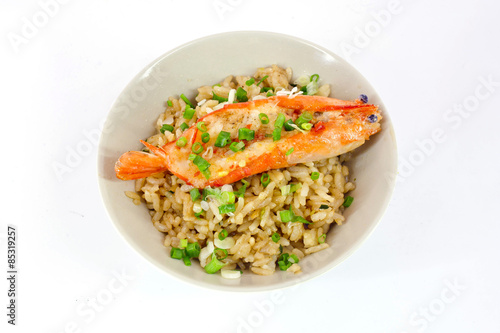 garlic fried rice with prawn sliced and vegetable on top