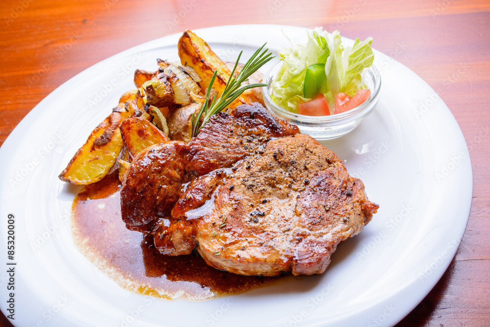 Grilled steak with roasted potatoes and salad