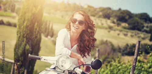 Portrait of summer girl on scooter  - Outdoor on Tuscany hiills. photo