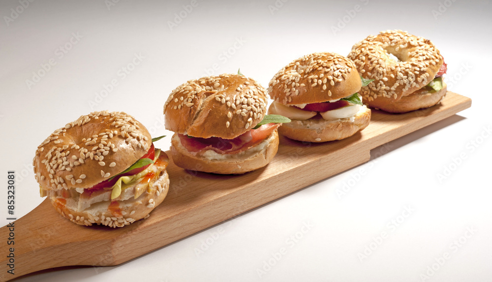 Mini  bagel sandwich with tomato cheese and ham 