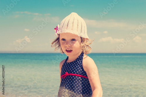 Funny little girl  on the beach. The image is tinted.