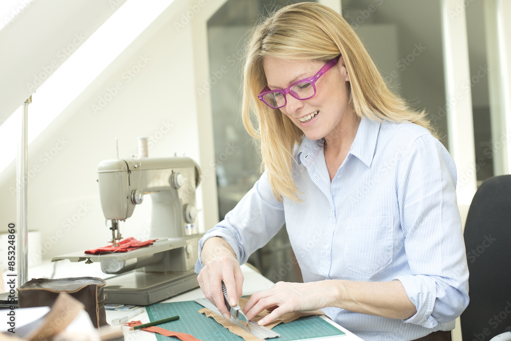 Smiling woman tailoring Smiling woman tailoring