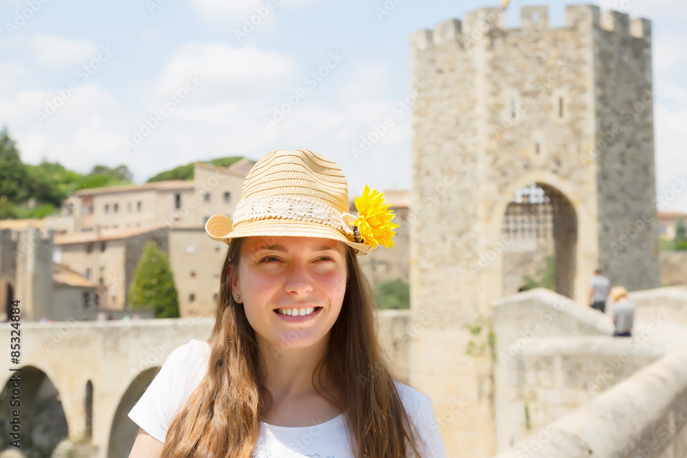  female tourist with old medieval stone bridge with gate