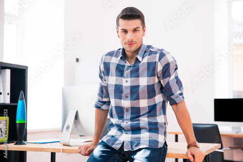 Businessman sitting on the table in office