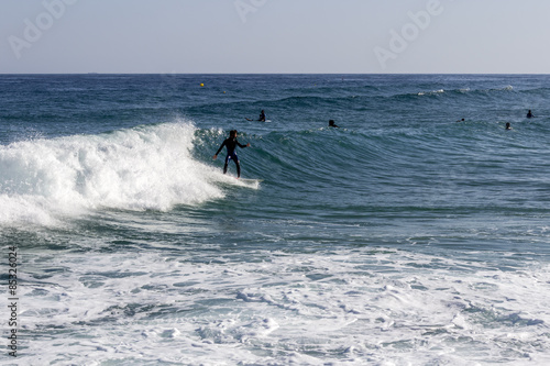 Ocean view and people surfing in Tavira Island, Algarve