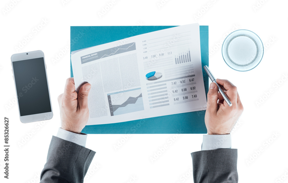 Business man checking a financial report Business man checking a financial report