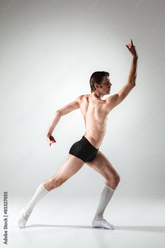 The young attractive modern ballet dancer on white background The young attractive modern ballet dancer on white background