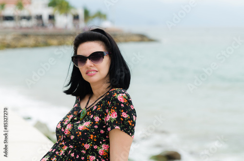 Young attractive Caucasian woman enjoys sun on ocean resort 