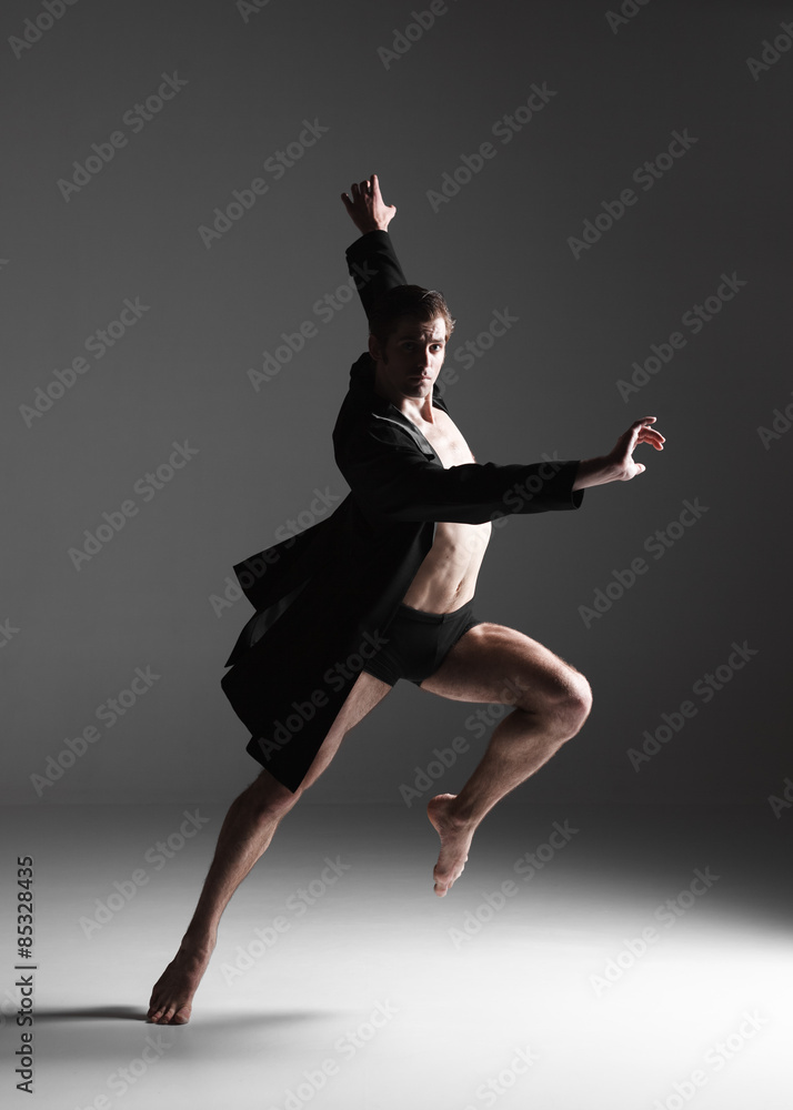 The young attractive modern ballet dancer on white background The young attractive modern ballet dancer on white background