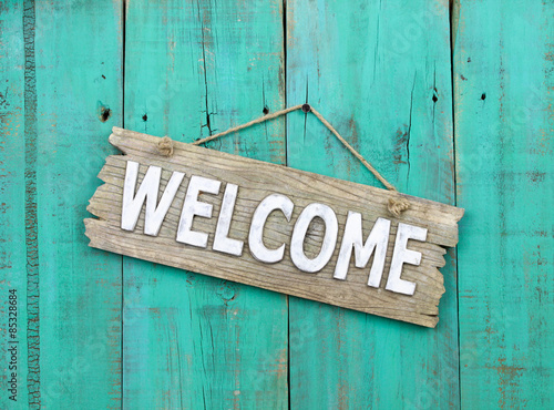Welcome sign hanging on rustic background