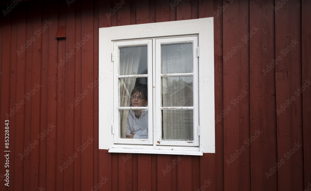 Norway, Lofoten, woman looking through window Norway, Lofoten, woman looking through window
