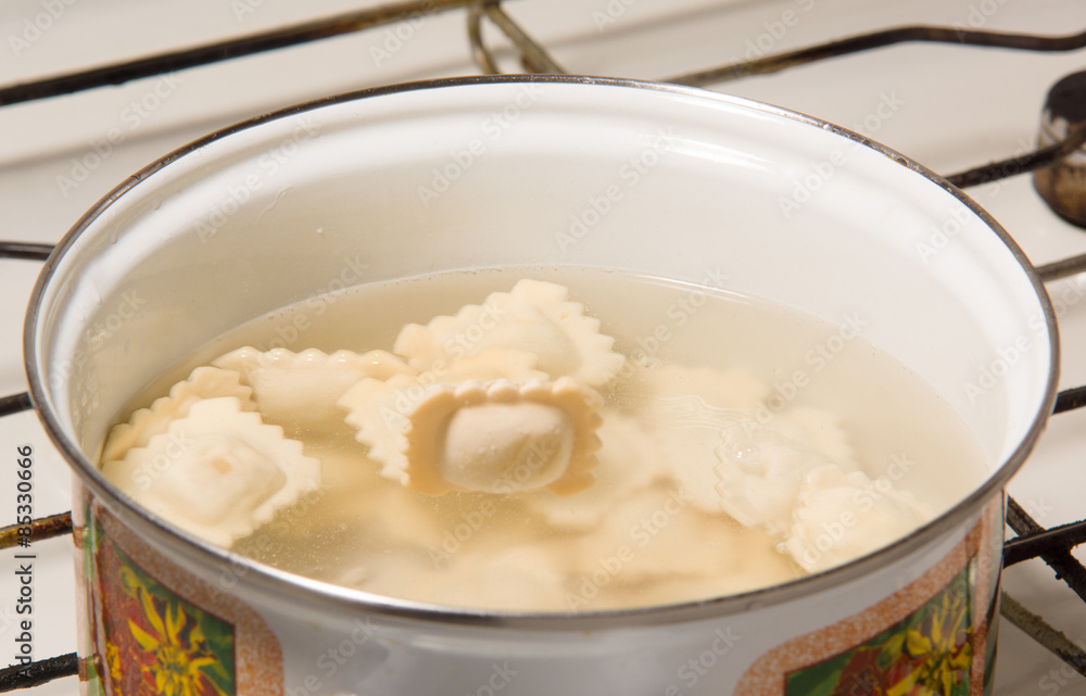 the dumplings cooks in a pan with the boiling water the dumplings cooks in a pan with the boiling water