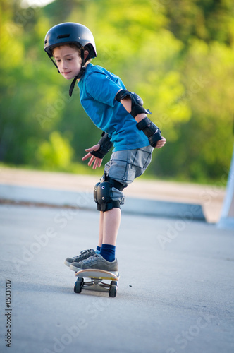 young boy learning how to skateboard