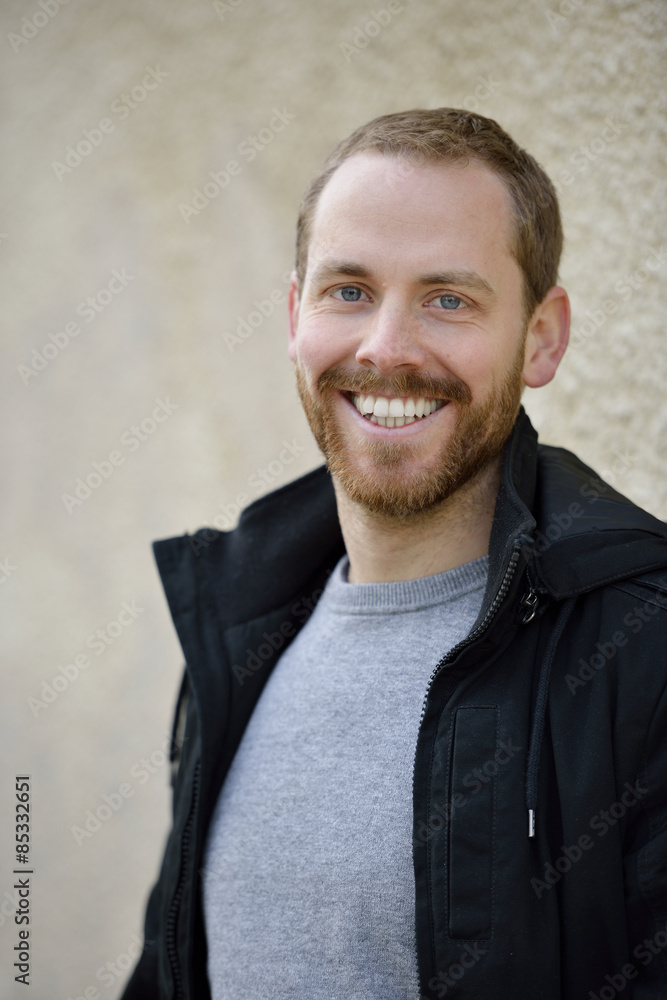 Portrait of laughing young man wearing black jacket Portrait of laughing young man wearing black jacket