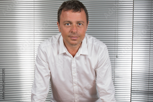 Attractive and Confident business man smiling at office