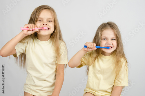 Two sisters brushing their teeth #85334822