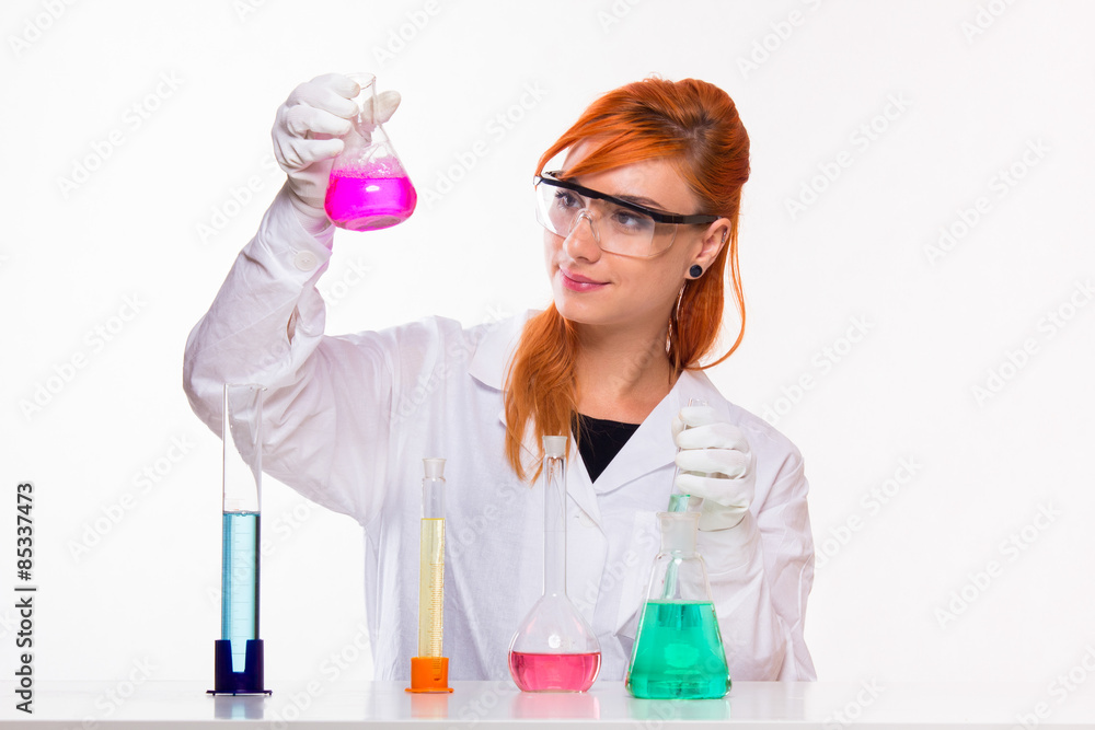 Chemist woman looks at the glass in the lab Chemist woman looks at the glass in the lab
