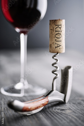 Glass of red wine, corkscrew and wine cork with the word 'Rioja' photo