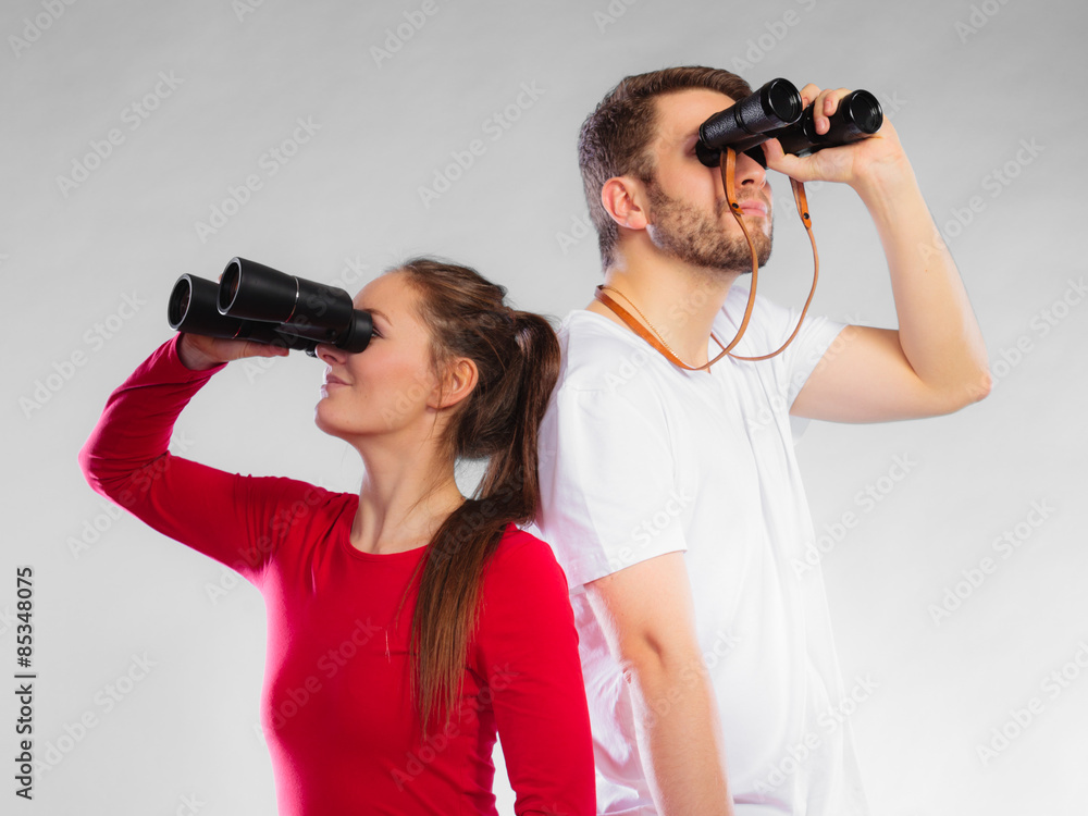 Couple looking through binoculars Couple looking through binoculars