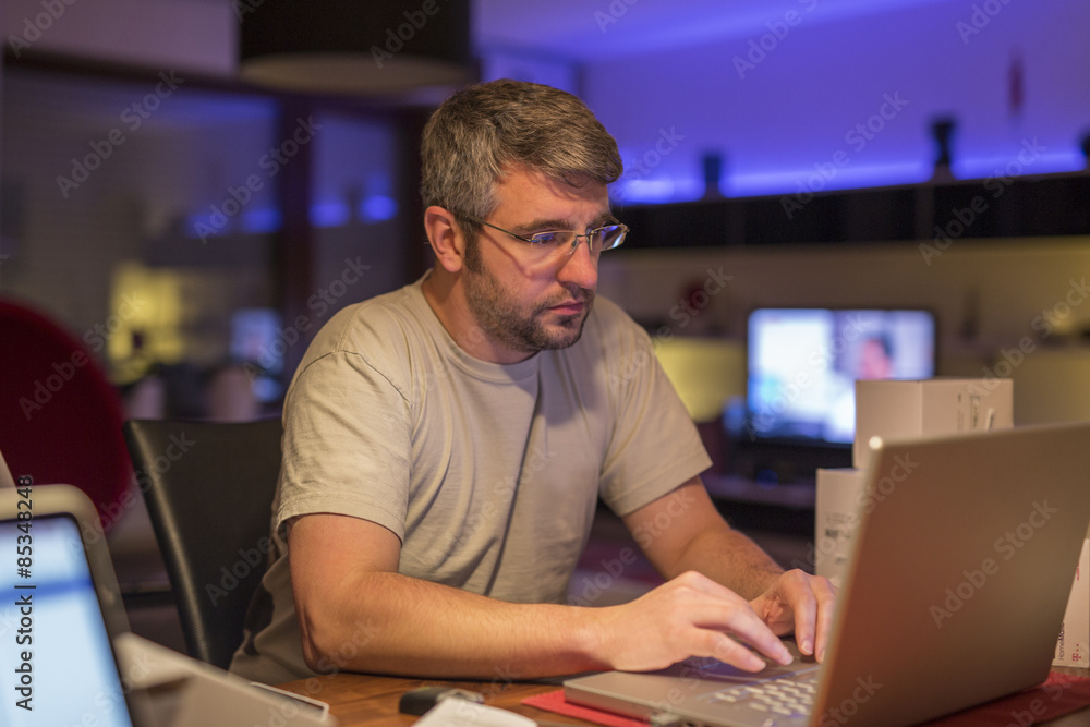 Man using laptop at desk Man using laptop at desk