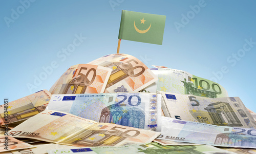 Flag of Mauritania sticking in a pile of various european bankno